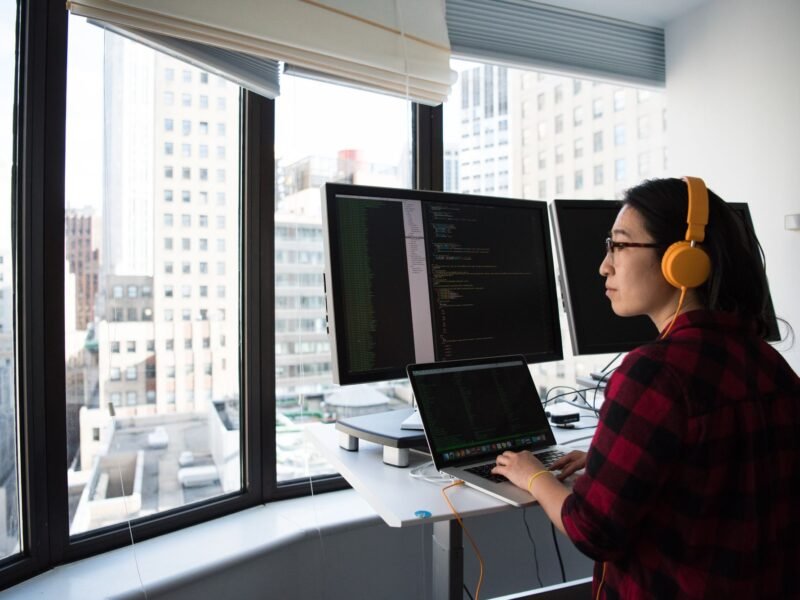 A designer working at a laptop in an office