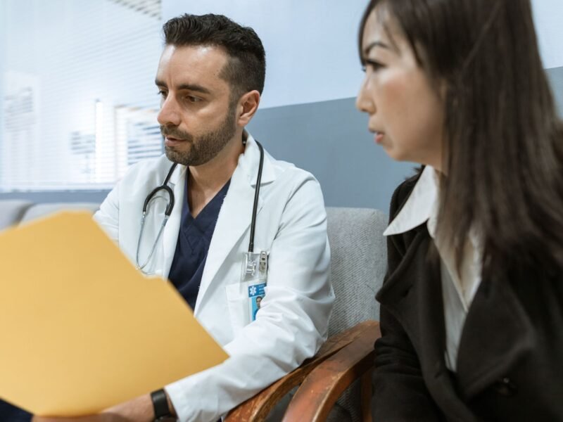 A doctor talking with a patient in a consulting room