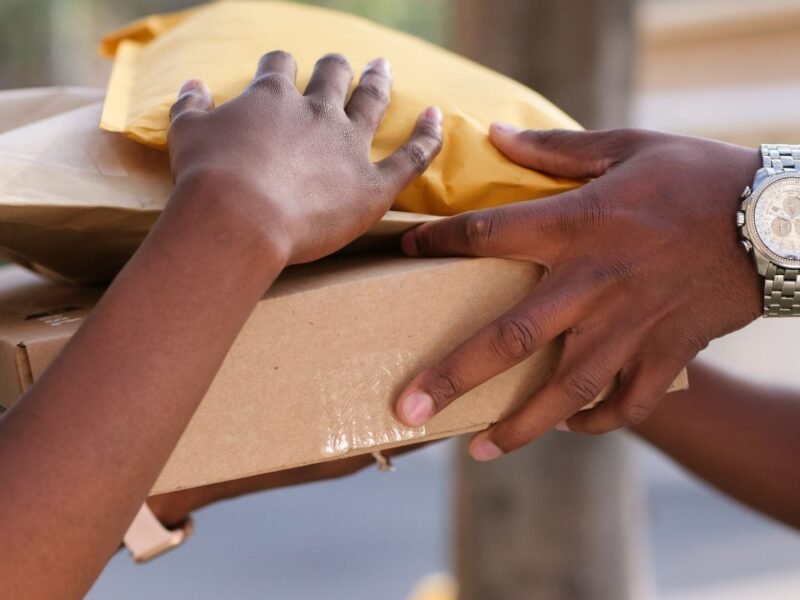 Hands packing a customer order into a box on a workbench