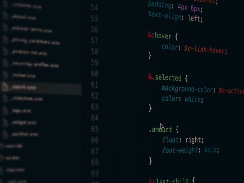 A code editor on a dark screen showing CSS rules for links and buttons