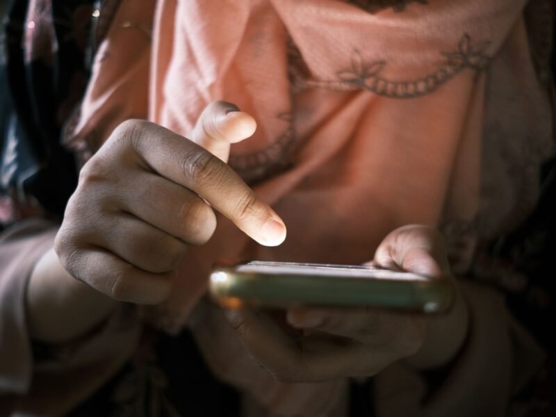 A person using a mobile phone with one hand